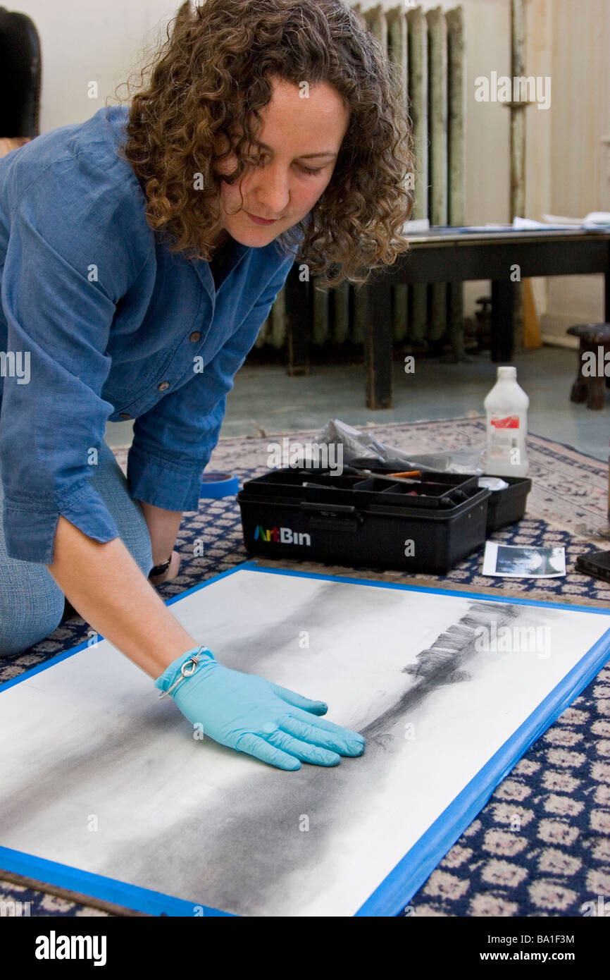 Female charcoal artist works on floor of studio Stock Photo Alamy