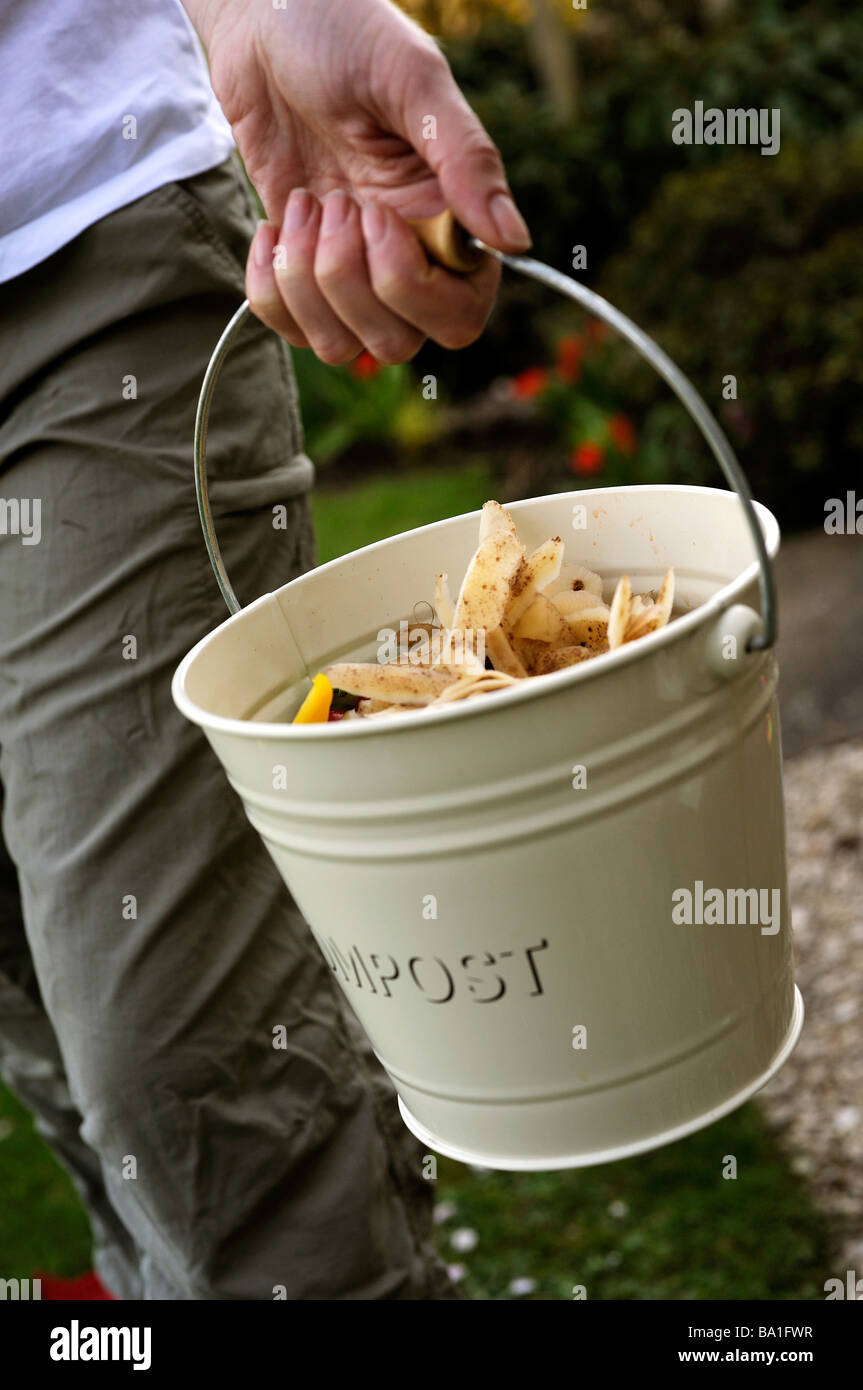 Woman taking out compost Stock Photo