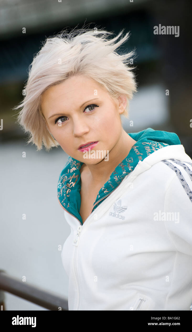 Pretty young blonde girl wearing a white adidas top Stock Photo - Alamy
