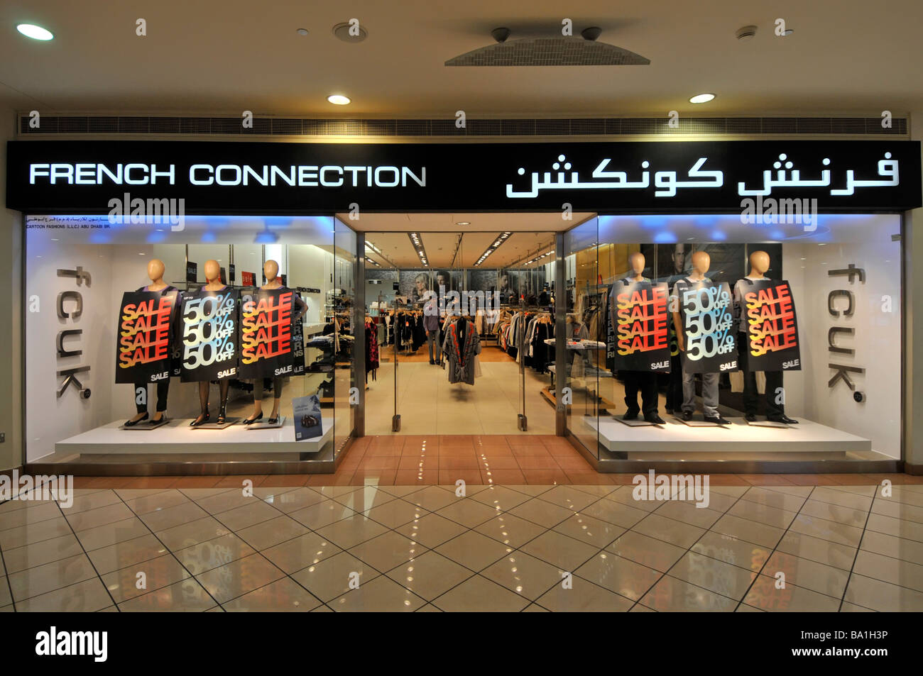 Marina shopping mall French Connection shop front with two store window sale displays & bilingual sign above entrance Abu Dhabi UAE Middle East Asia Stock Photo