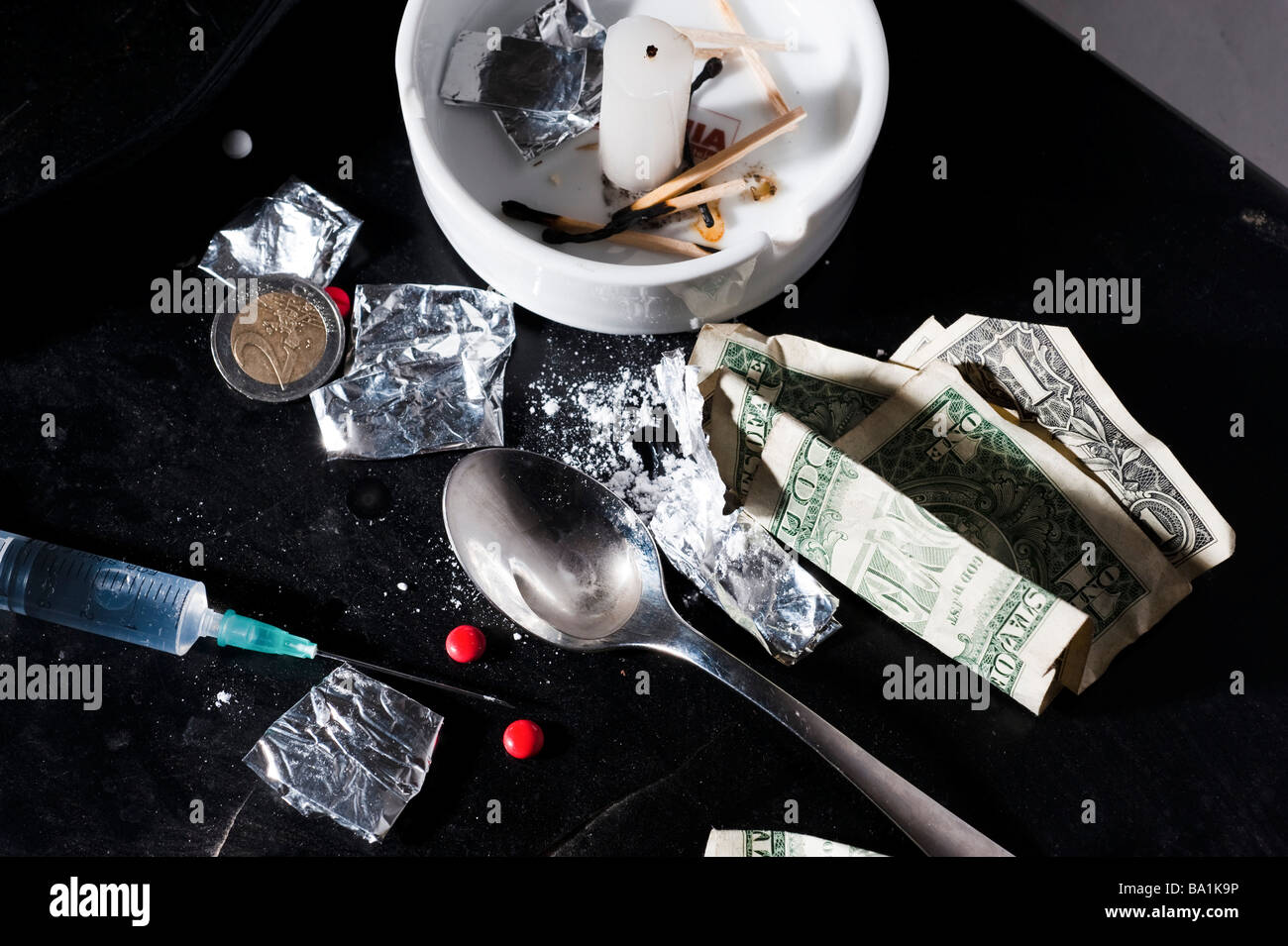 Drug abuse concept Heroin shoot up tools and drugs and money Stock Photo