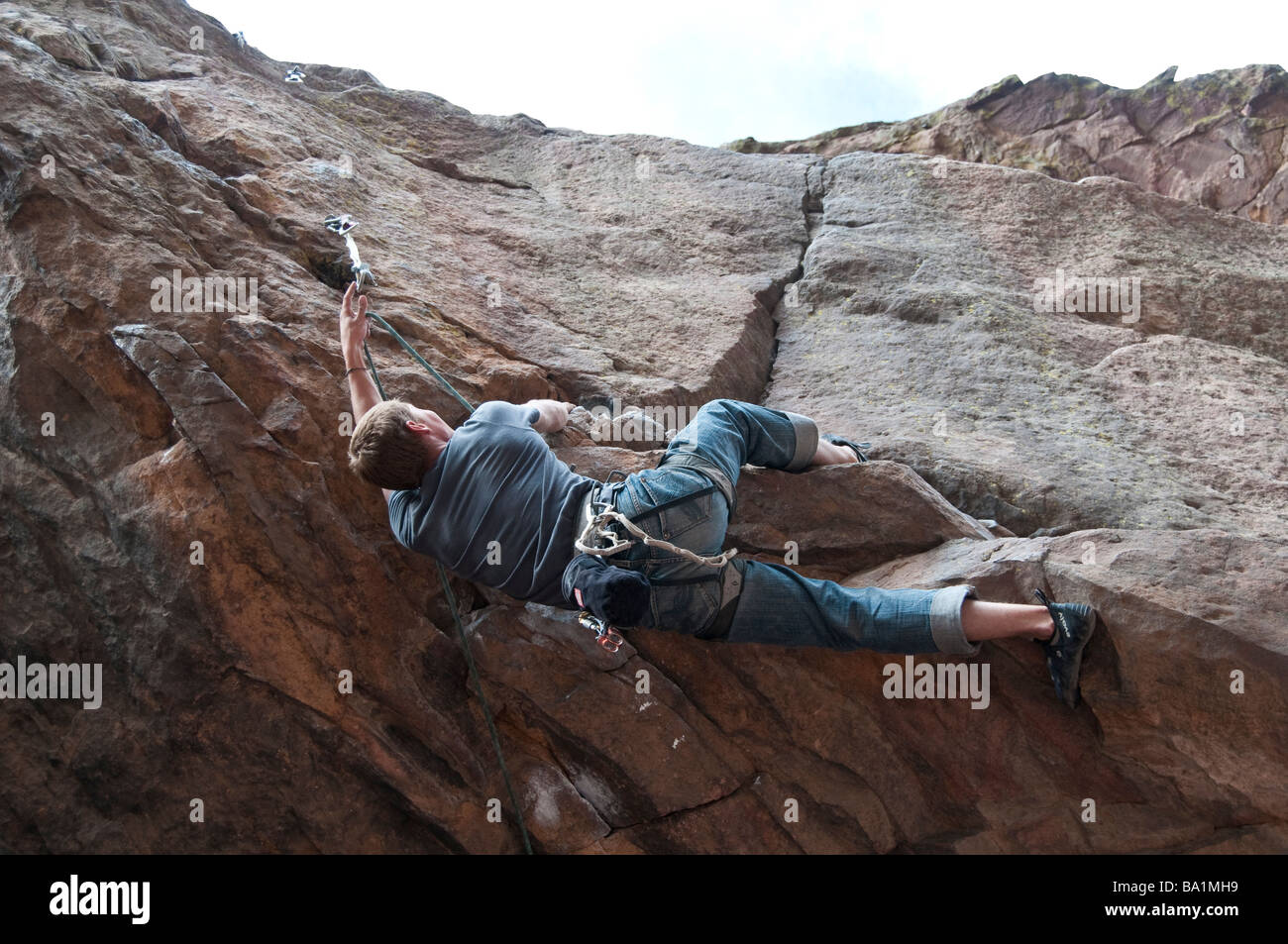Man climbs in a shallow cave, Eldorado Canyon State Park, Eldorado Springs, Colorado. Stock Photo