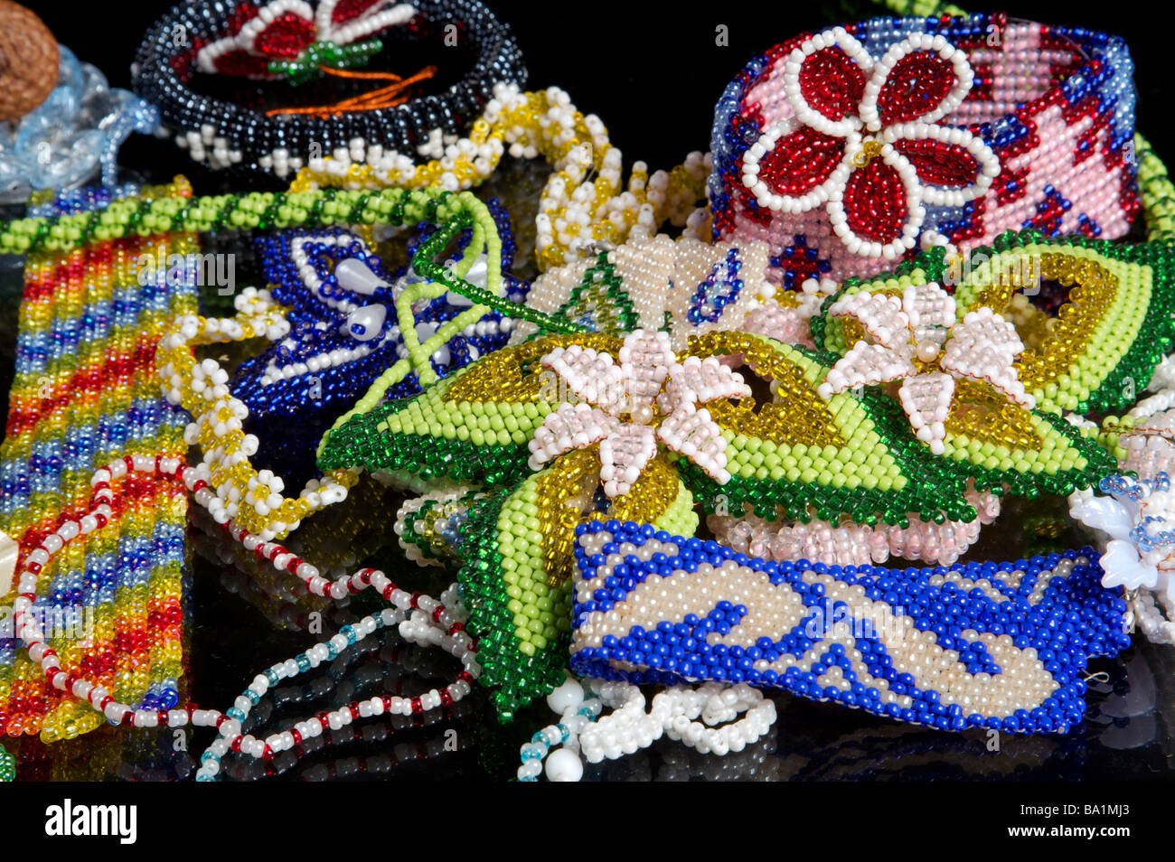Beading mat with finished designs, needles and colourful beads Stock Photo  - Alamy