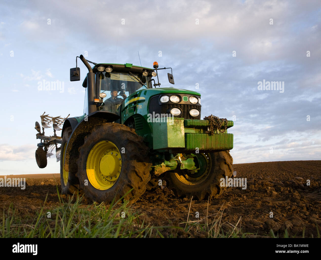A Tractor turning on the headland with a plough Stock Photo Alamy
