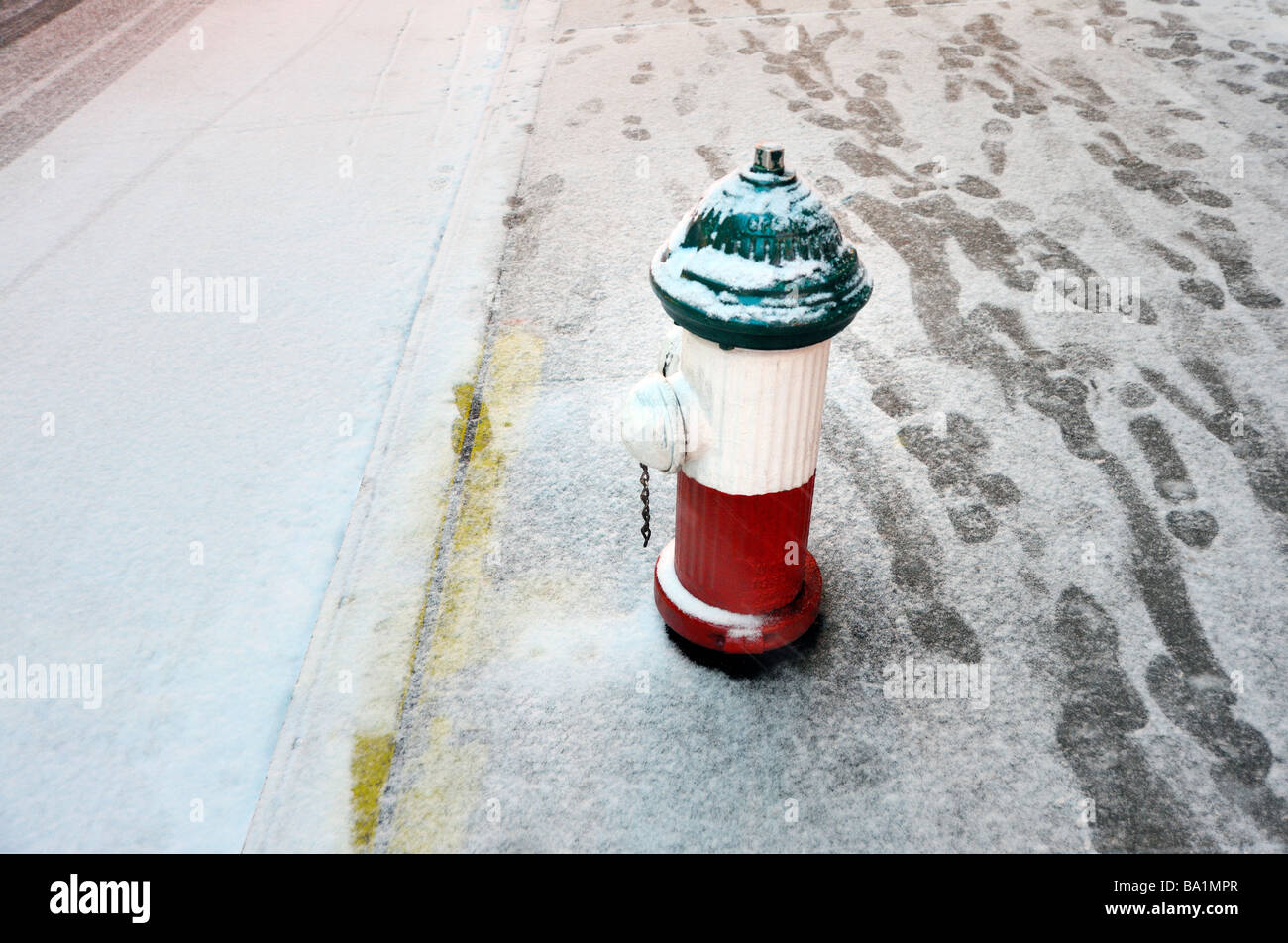 A snow storm in New York City A fire hydrant on Mulberry Street in Little Italy painted with the colors of the Italian flag. Stock Photo