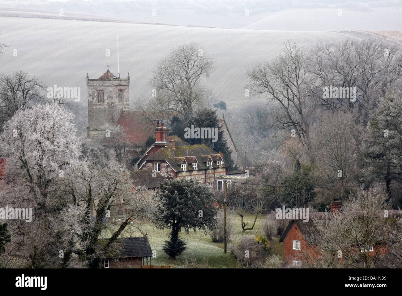 Village church, St. John the Baptist church, at Ebbesbourne Wake, Wiltshire UK covered with hoar frost hoarfrost  in January Stock Photo