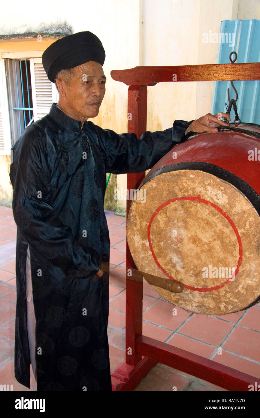 Monk sounding a drum at a temple in Hoi An Vietnam Stock Photo