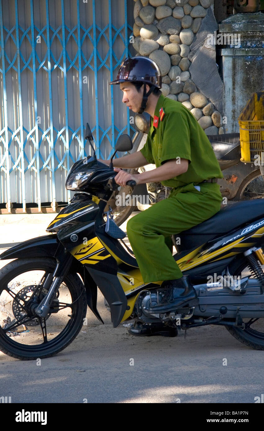Vietnamese soldier riding a motorbike in Hoi An Vietnam Stock Photo