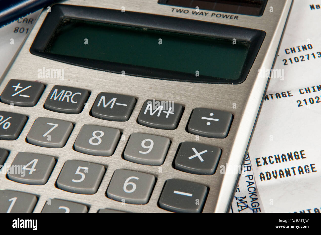 Calculator on top of receipts Stock Photo
