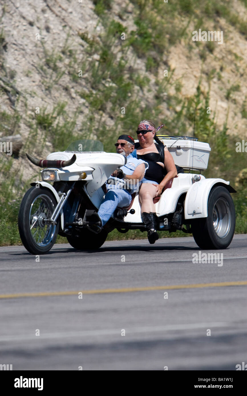 Older man woman riding motor trike South Dakota Black Hills route Alternative 14 Sturgis Motorcycle Rally Stock Photo