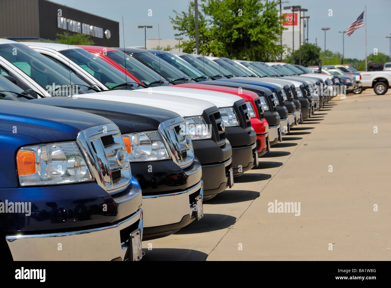 A row of new Ford Pickup's on a new car dealership lot. Stock Photo