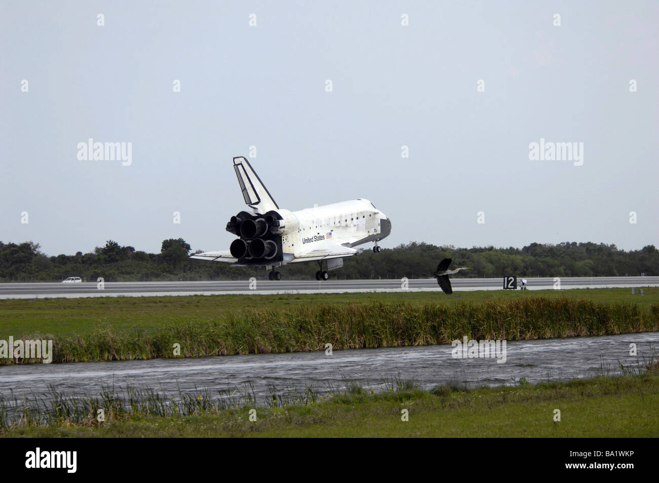 Space Shuttle Discovery touches down on the runway at Kennedy Space Center. Stock Photo
