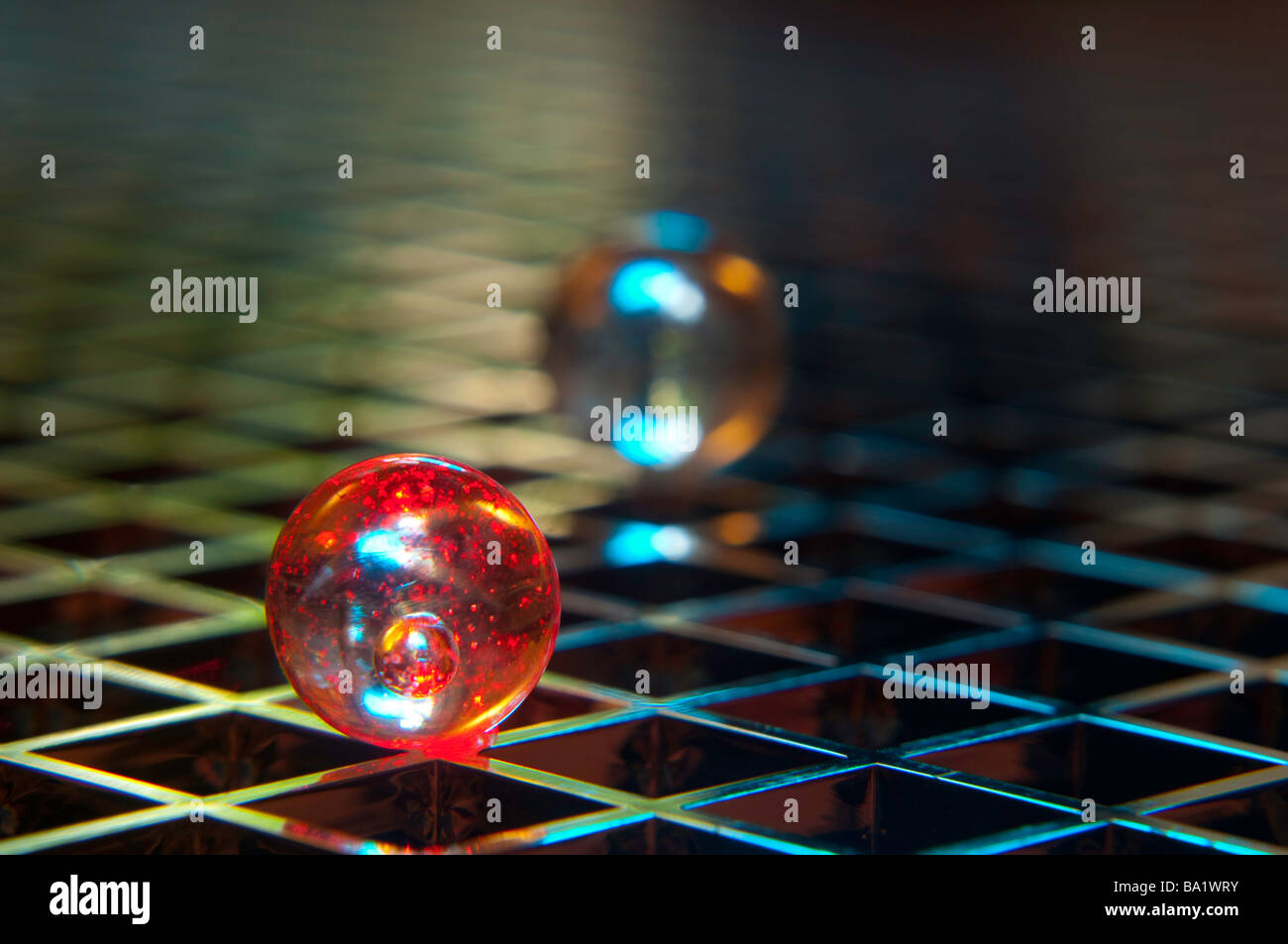 Abstract of glass marbles on a reflective grid Stock Photo
