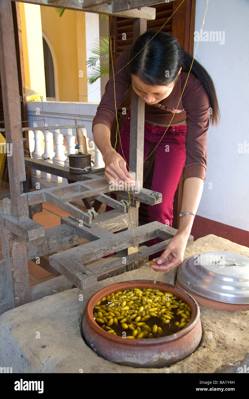 Vietnamese woman spinning silk from the silkworm cocoon in Hoi An Vietnam Stock Photo