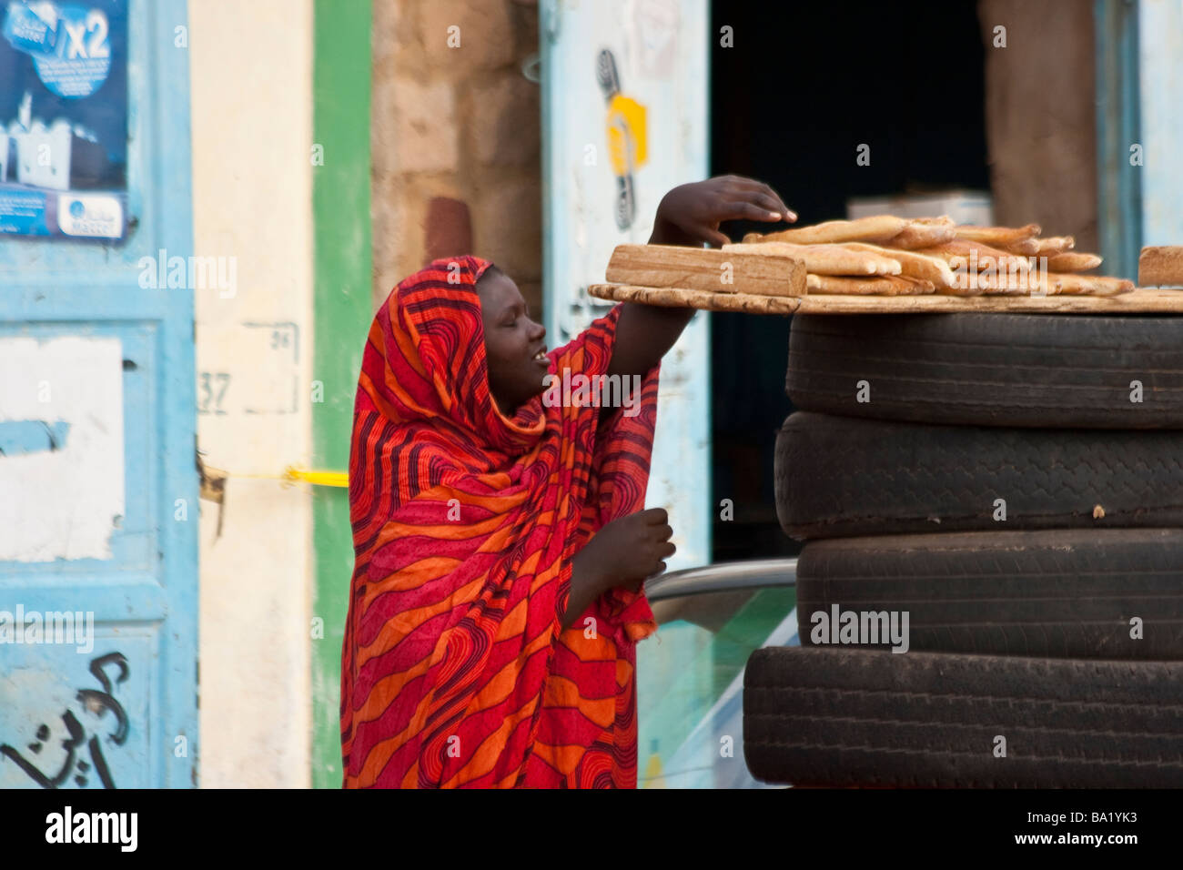 Woman Reaching for Bread in Ayoun el Atrous in Mauritania West Africa Stock Photo