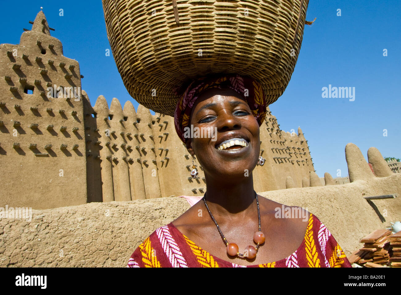 Smiling Malian Woman in front of the Great Mosque in Djenne Mali Stock Photo
