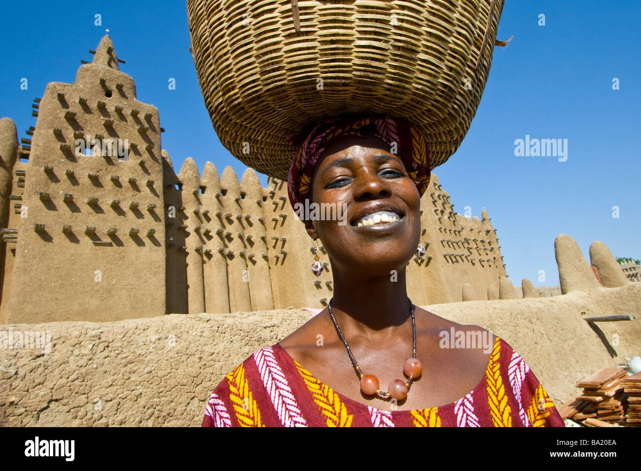Smiling Malian Woman in front of the Great Mosque in Djenne Mali Stock Photo