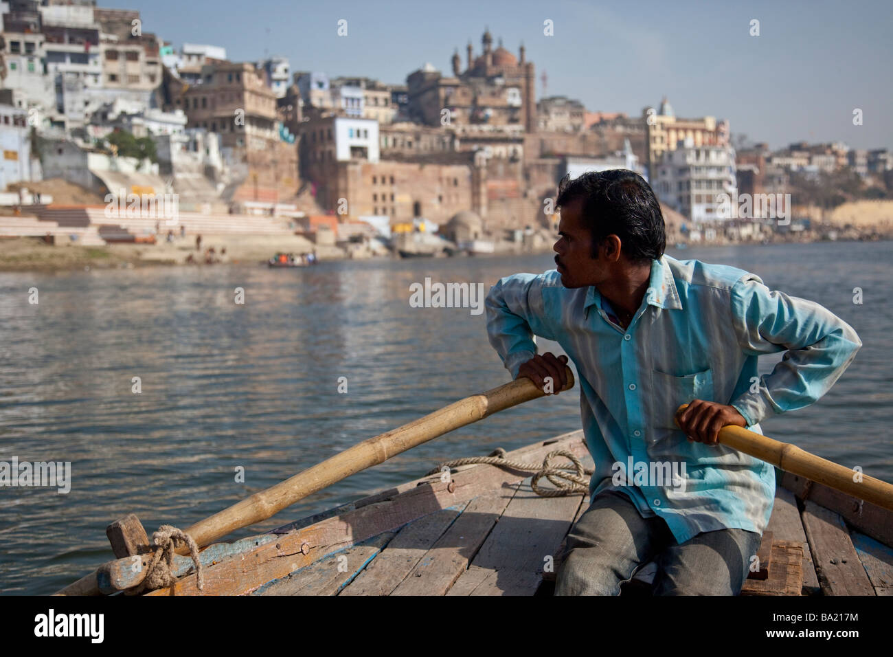 Rowboat and the Alamgir Mosque on the Ganges River in Varanasi India Stock Photo