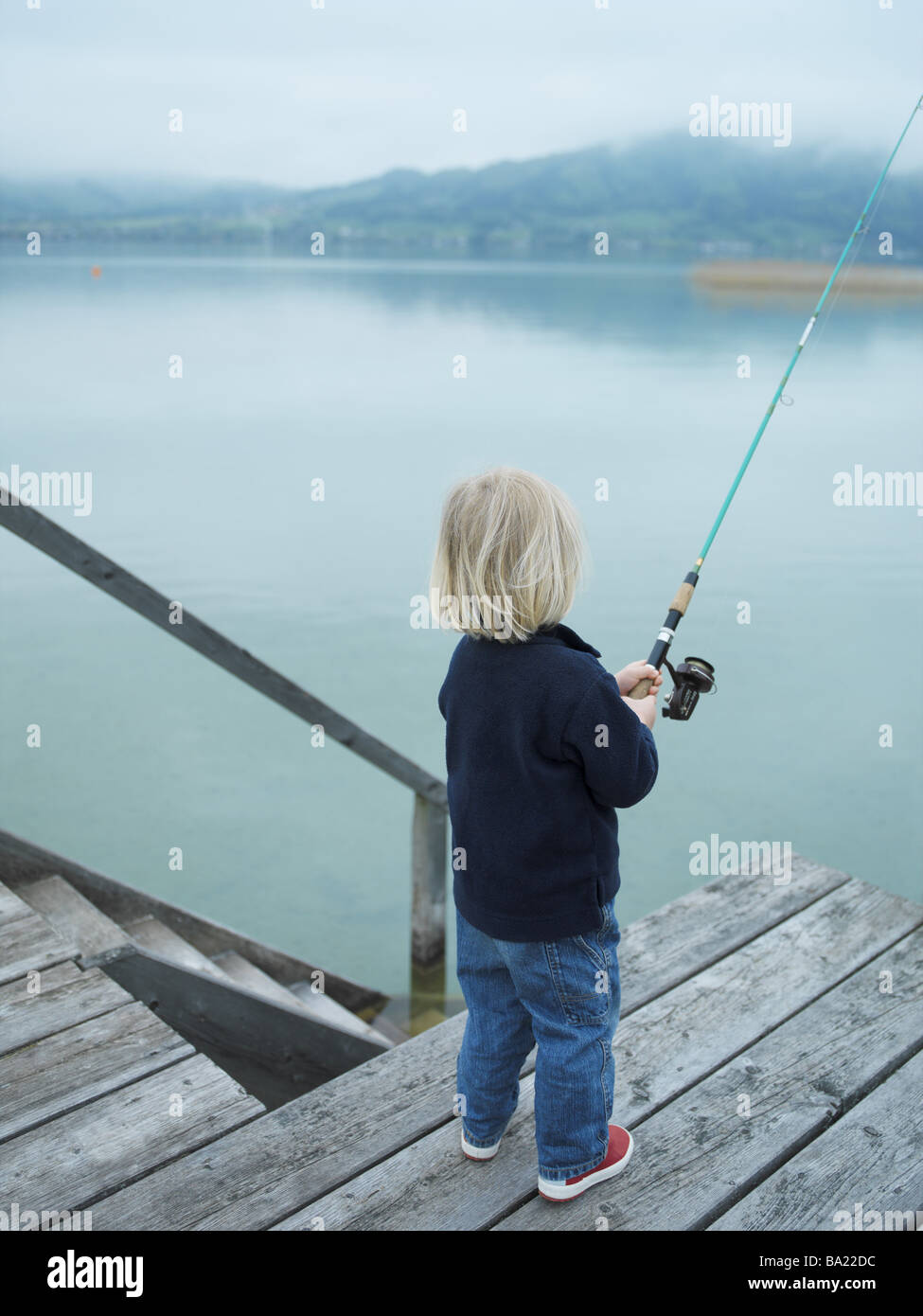 Boy on bridge fishing rod hi-res stock photography and images - Alamy