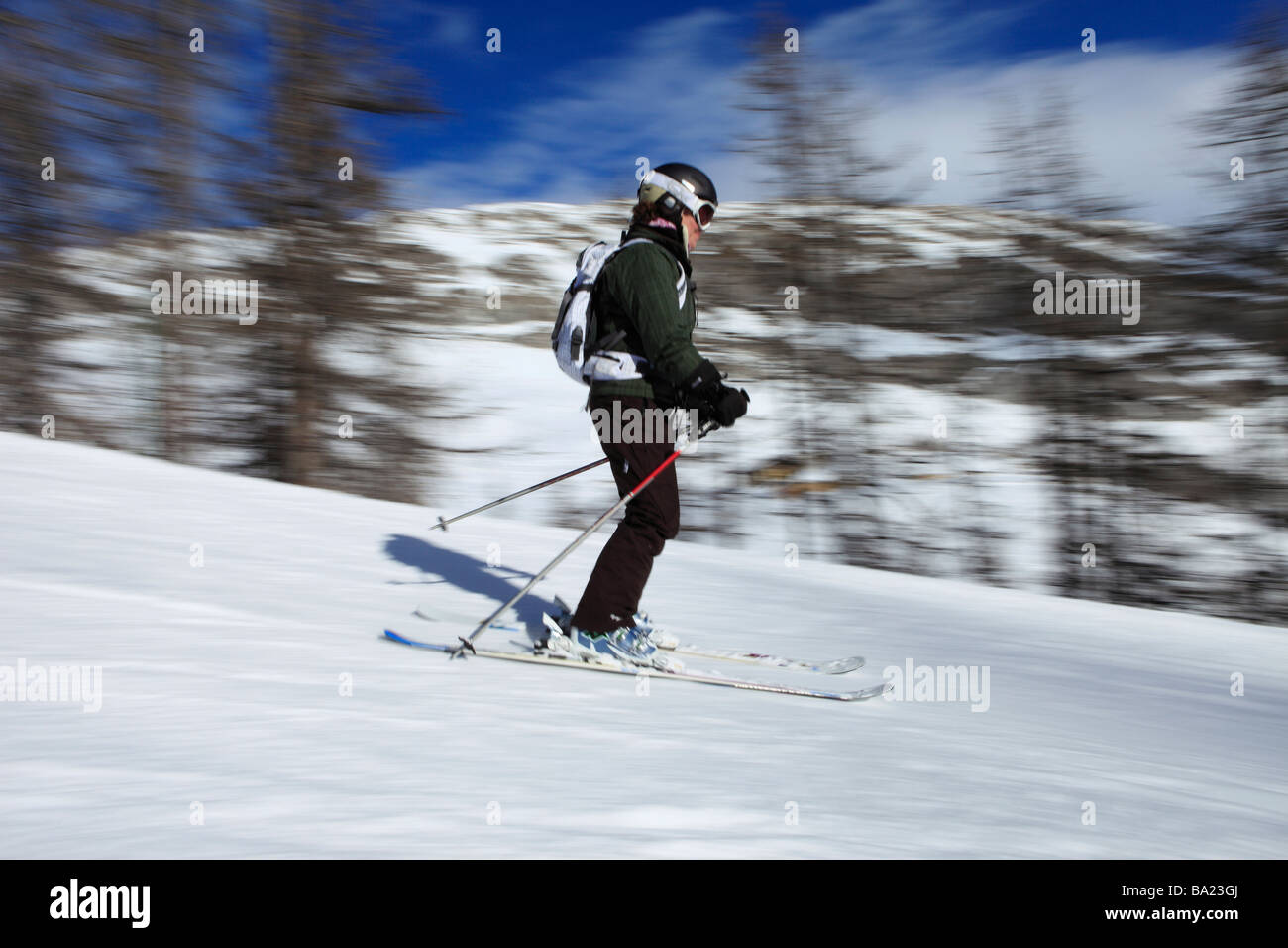 Skier takes a break at the edge of the piste in the ski resort of Tignes Le Lac, Espace Killy, France Stock Photo