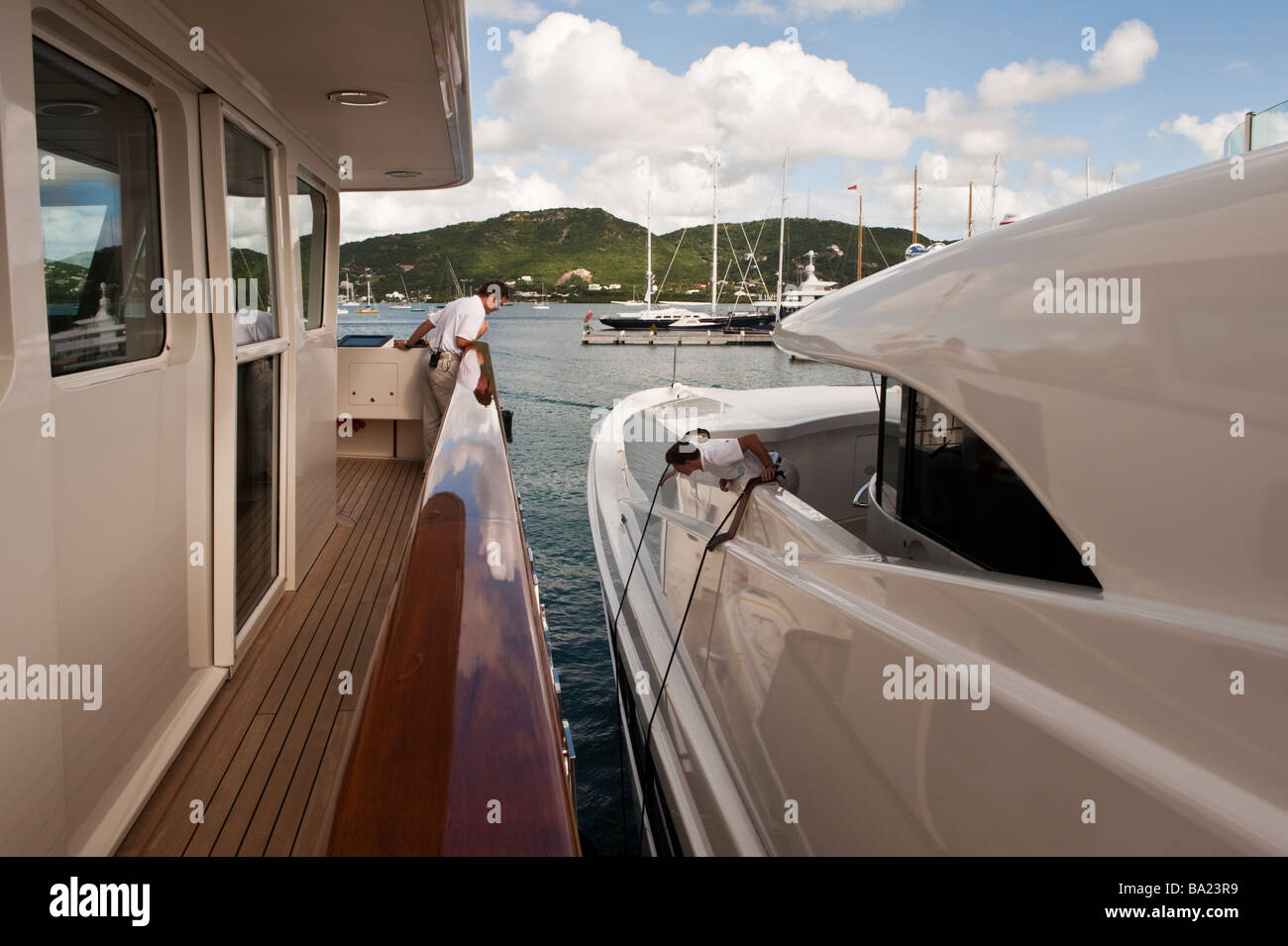 Slowly taking 'Big Aron' off the dock at Antigua Yacht Club marina Stock Photo