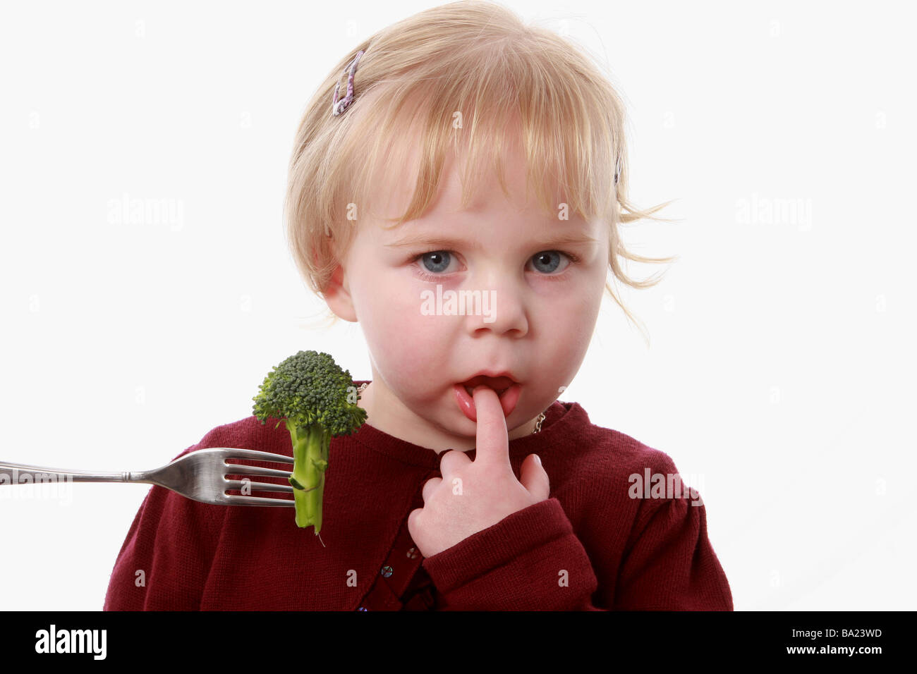 A little girl refuses Broccoli on a fork Stock Photo Alamy