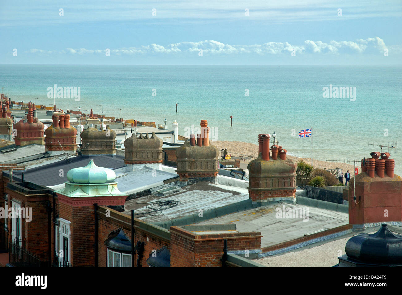 View over rooftops and flying the flag on the beach at Bexhill On Sea, East Sussex, England. Stock Photo