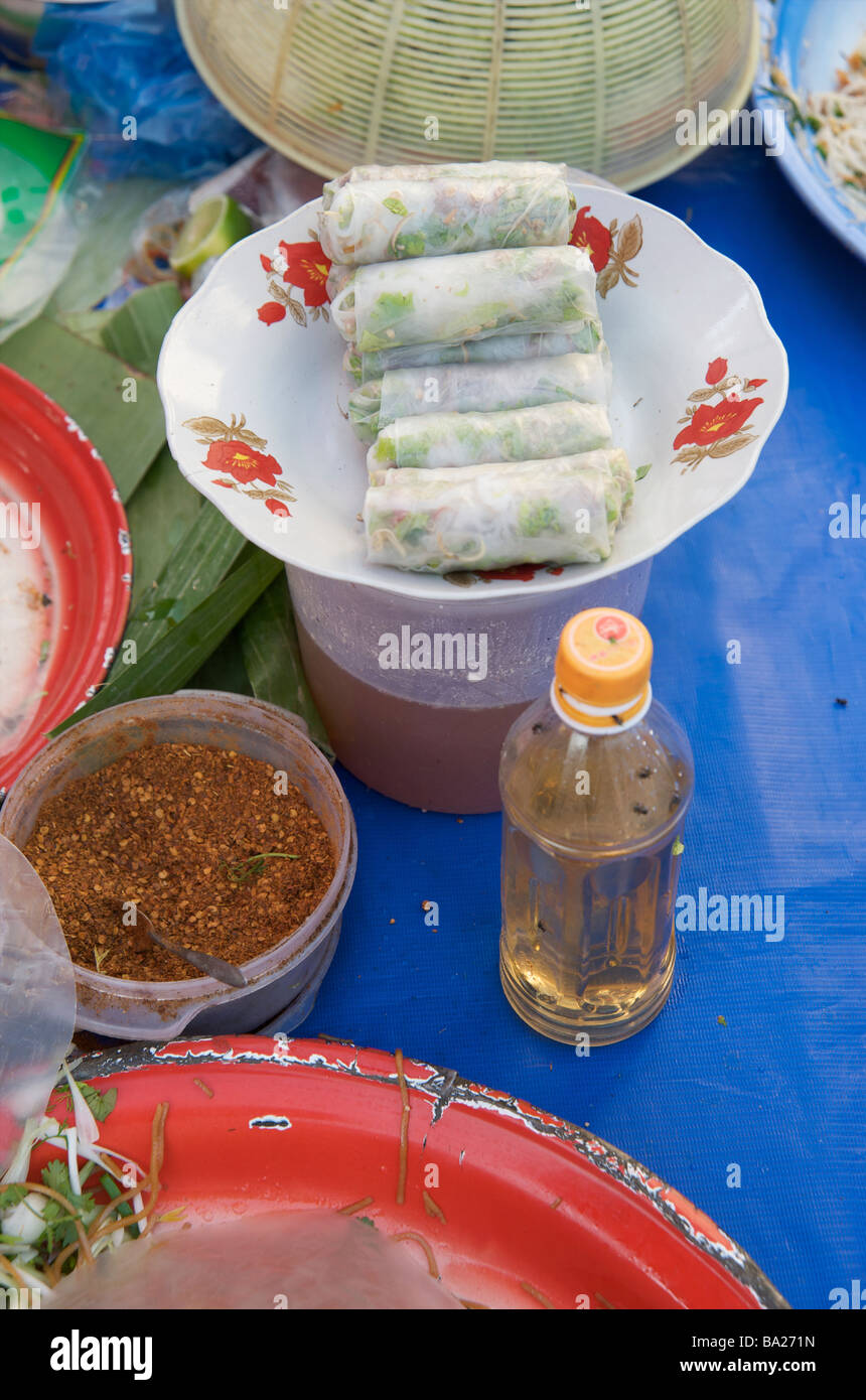 A close up of a bowl of spring rolls and spicy dipping sauce in Luang Prabang Laos Stock Photo