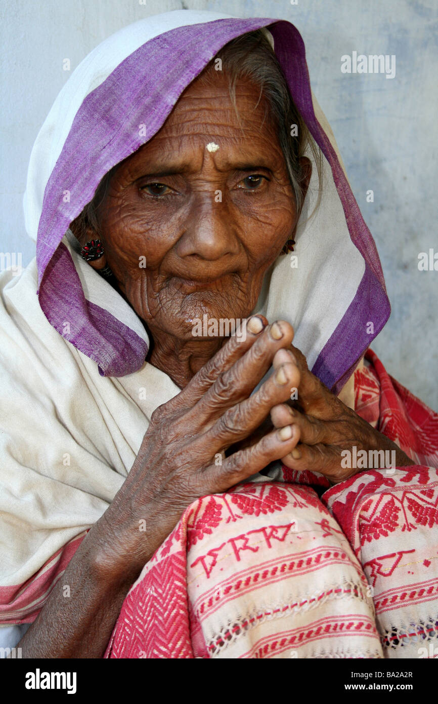 Portrait of an Elderly Indian Pilgrim With Hands Together In Prayer at a Monastery (Satra) on Majuli Island, Brahmaputra River Stock Photo