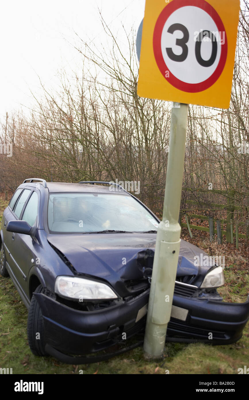 Car Wrapped Around Speed Limit Sign Stock Photo