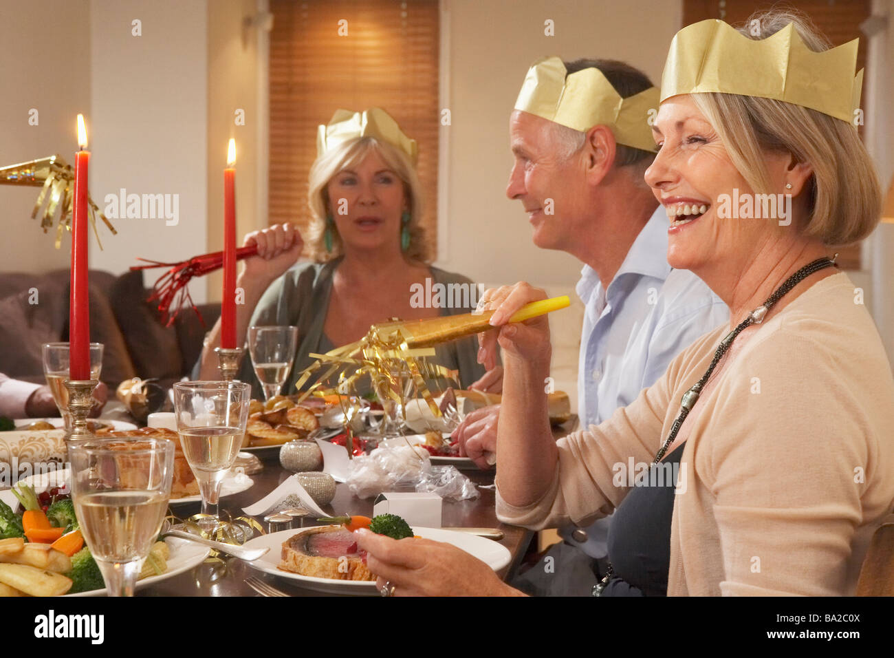 Friends Wearing Party Hats At A Dinner Party Stock Photo Alamy