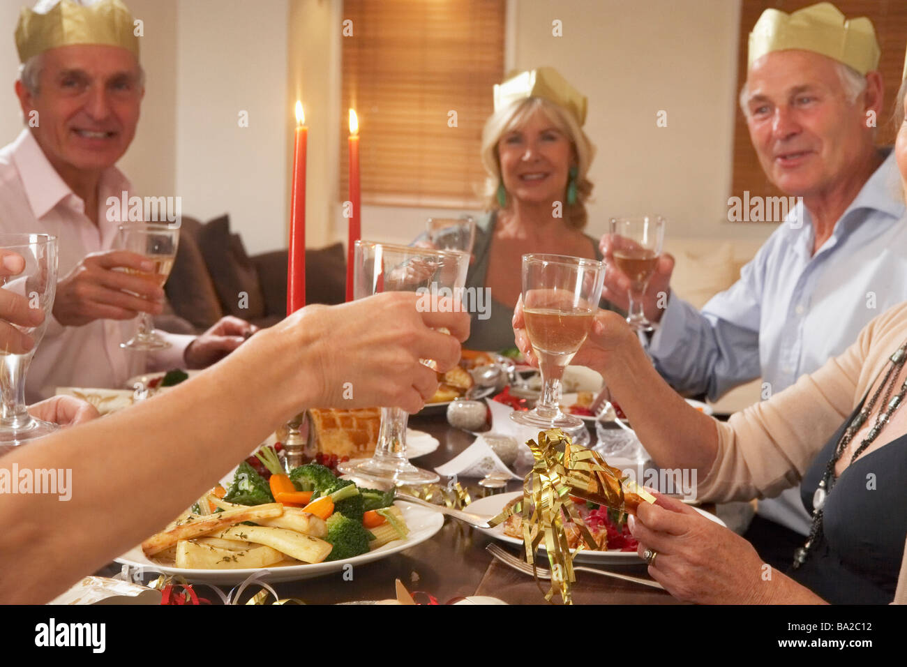 Friends Wearing Party Hats At A Dinner Party Stock Photo Alamy