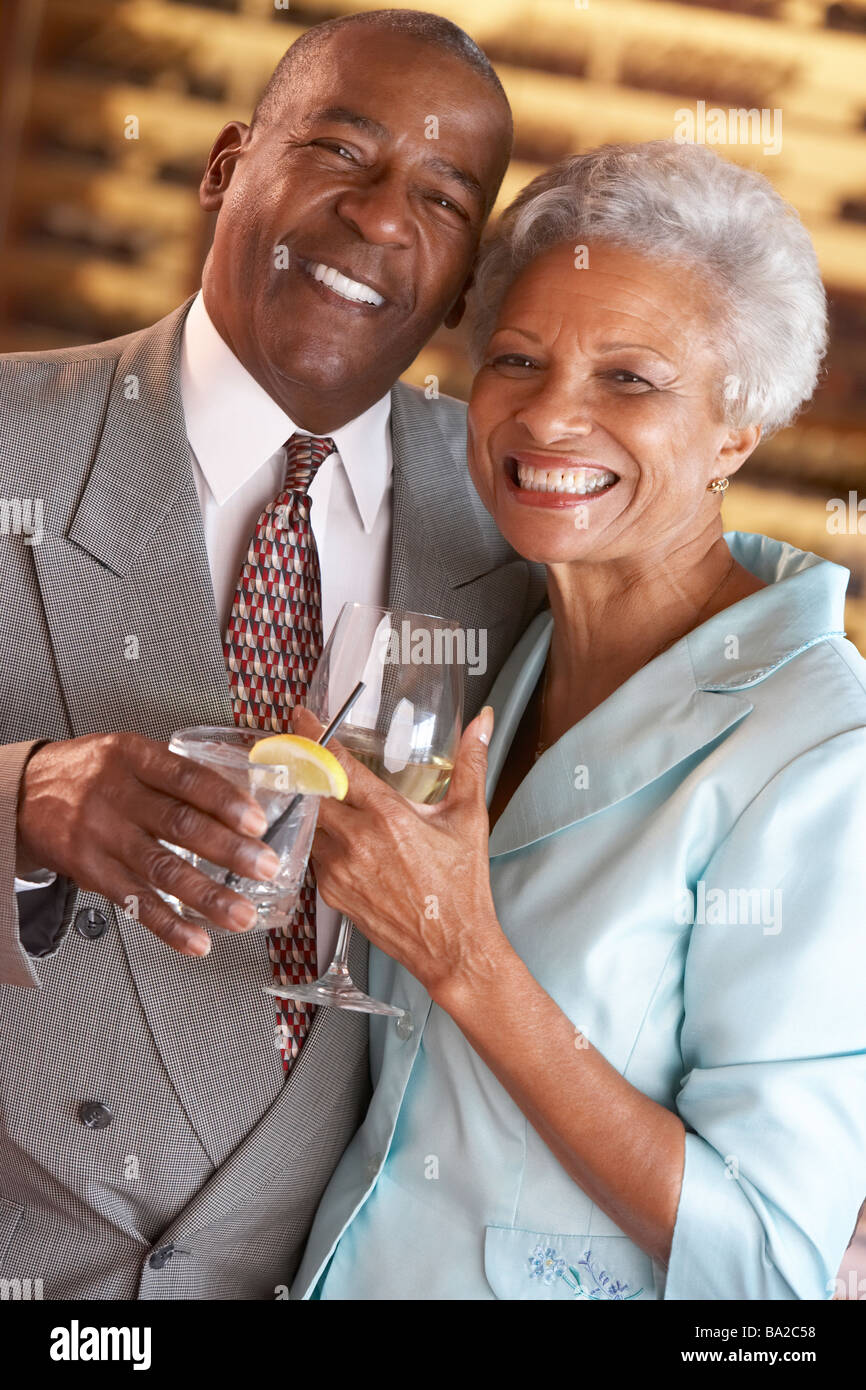 Couple Enjoying A Drink At A Bar Together Stock Photo