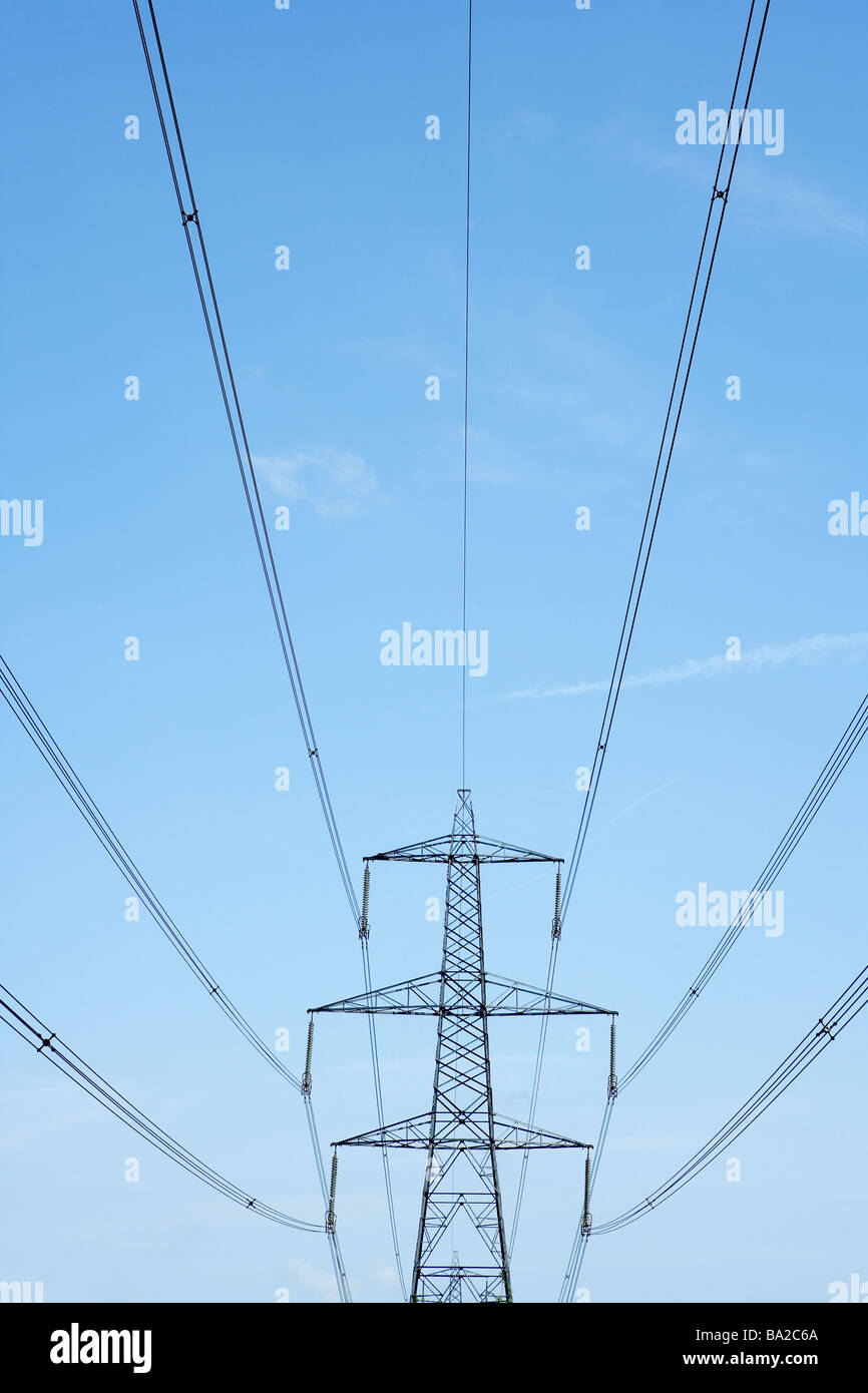 Electricity Pylons Against A Blue Sky Stock Photo - Alamy