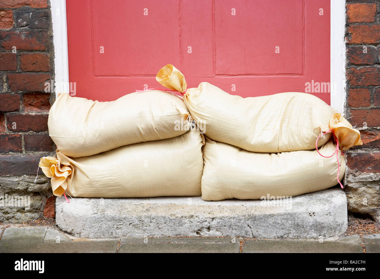 Sandbags Stacked In A Doorway In Preparation For Flooding Stock Photo