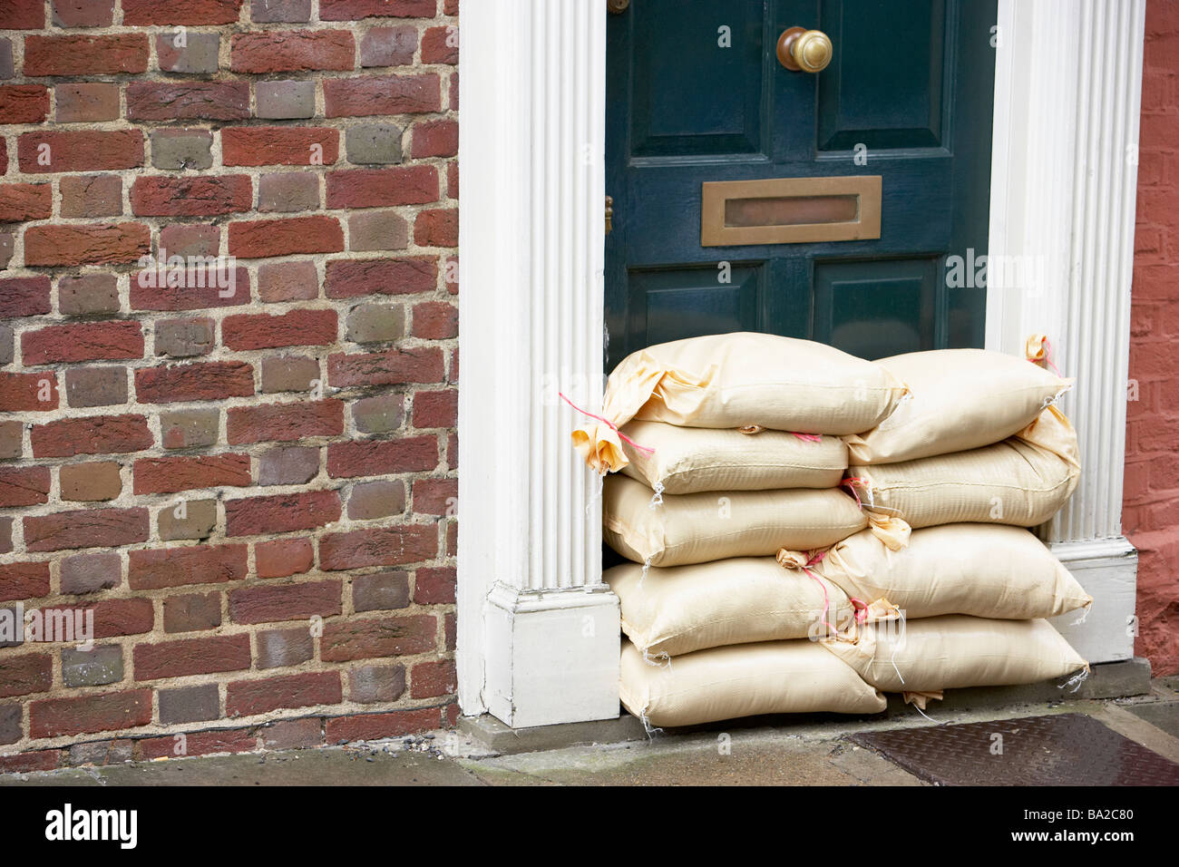 Sandbags Stacked In A Doorway In Preparation For Flooding Stock Photo