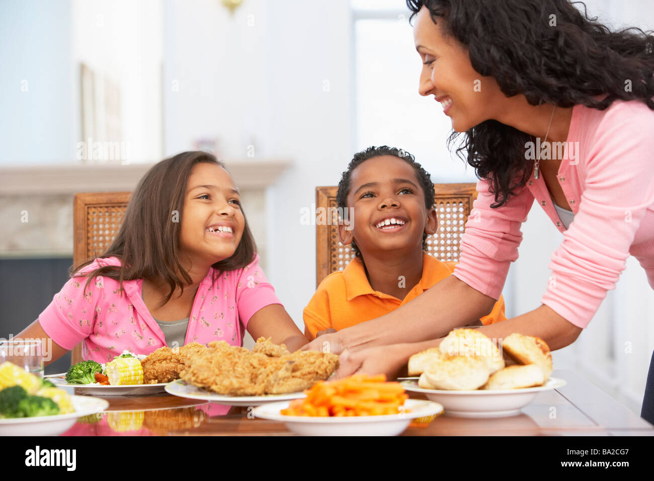 Mother Serving A Meal To Her Children At Home Stock Photo Alamy