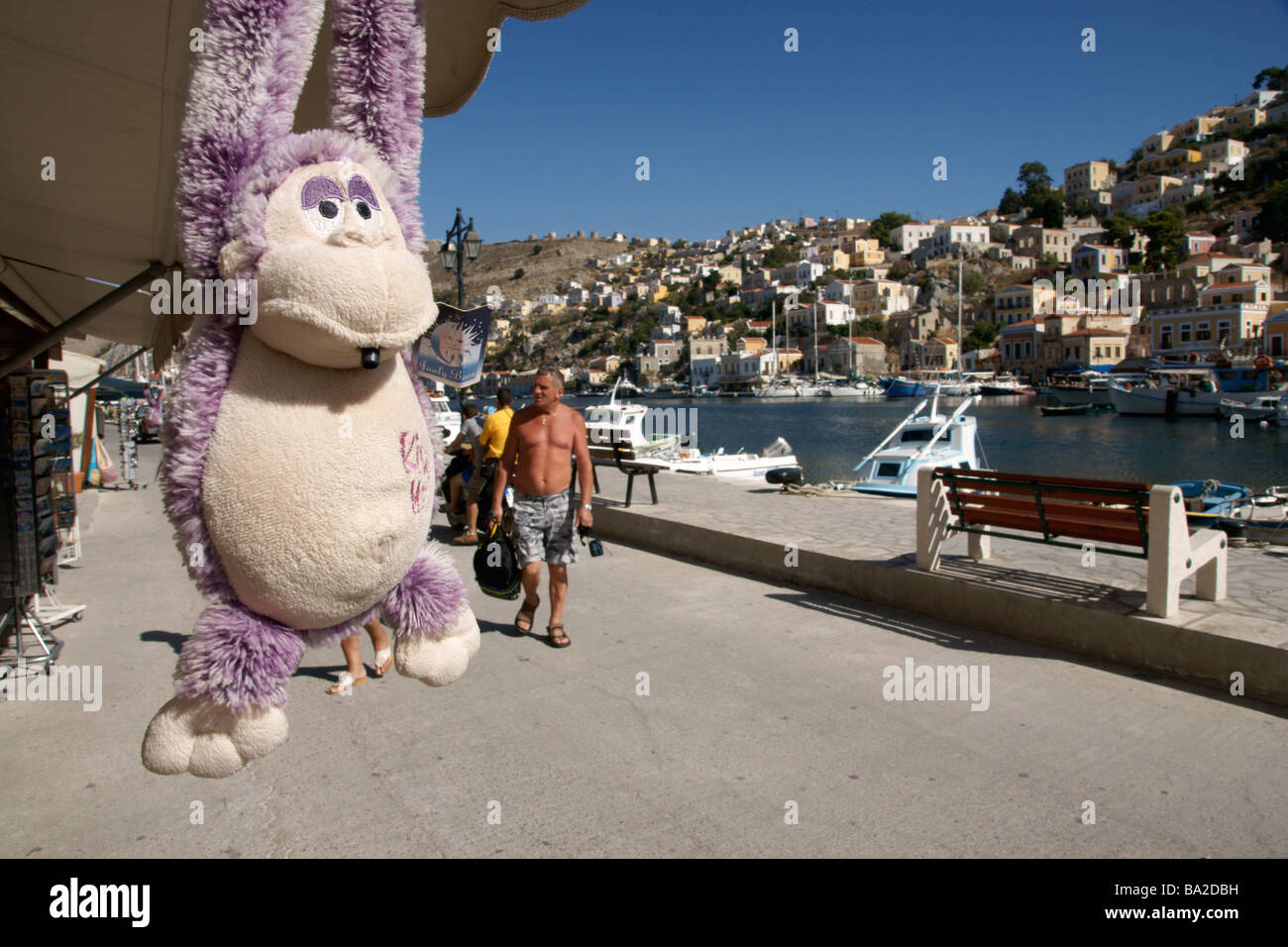 Swinging pink monkey onsale at the harbour of Symi Town, Symi Greece (c)  Marc Jackson Photography Stock Photo - Alamy