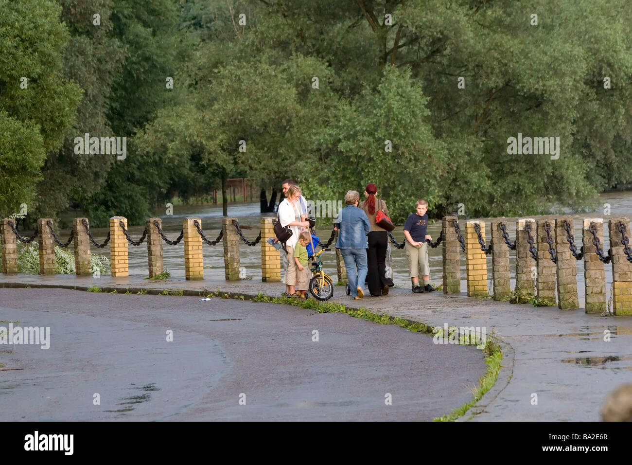 Poland, People looking at flooded river in Sanok Stock Photo