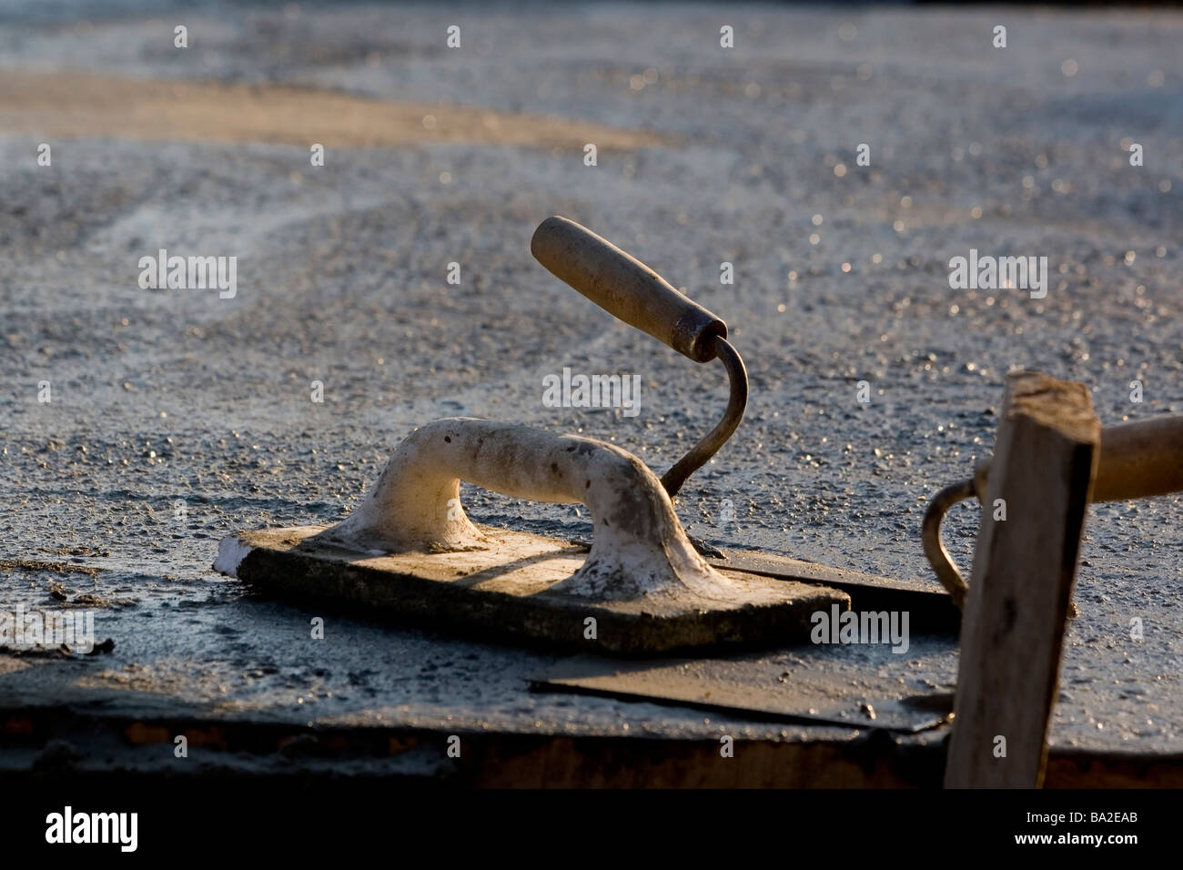 Spatula and rasp lying on cement construction Stock Photo - Alamy