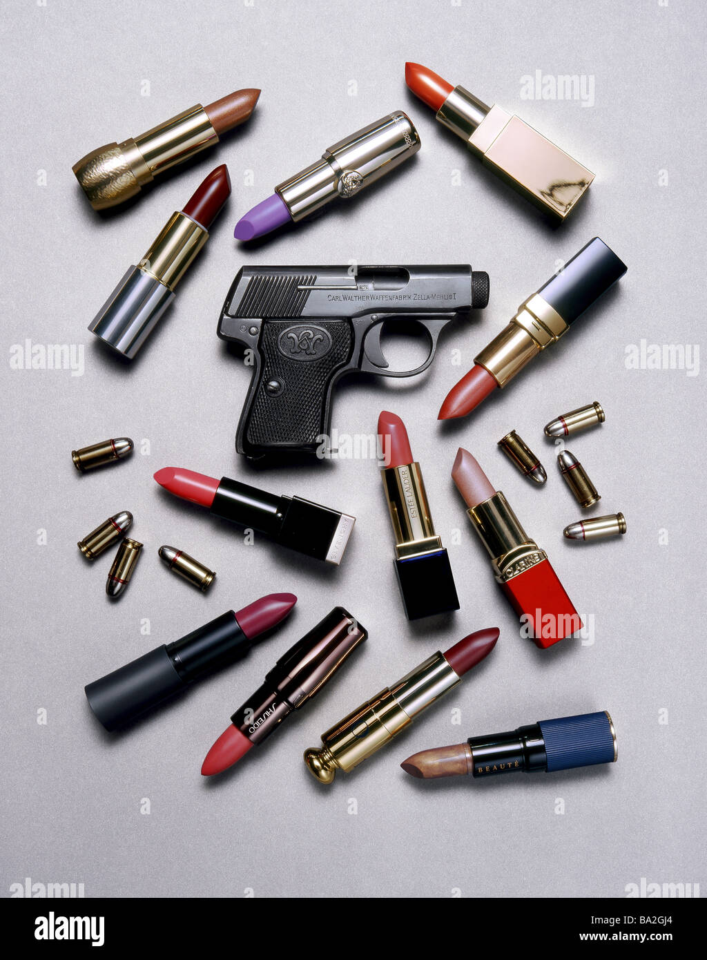 Pistol patrons lipsticks differently weapon handgun cartridge-husks make-up  colors different concept defense self-defense Stock Photo - Alamy