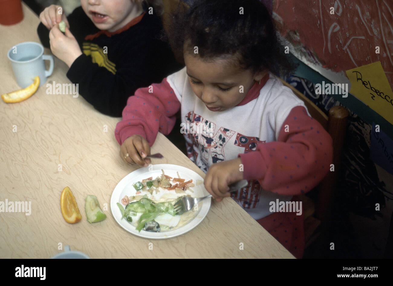 Nursery school girl eating lunch Stock Photo Alamy