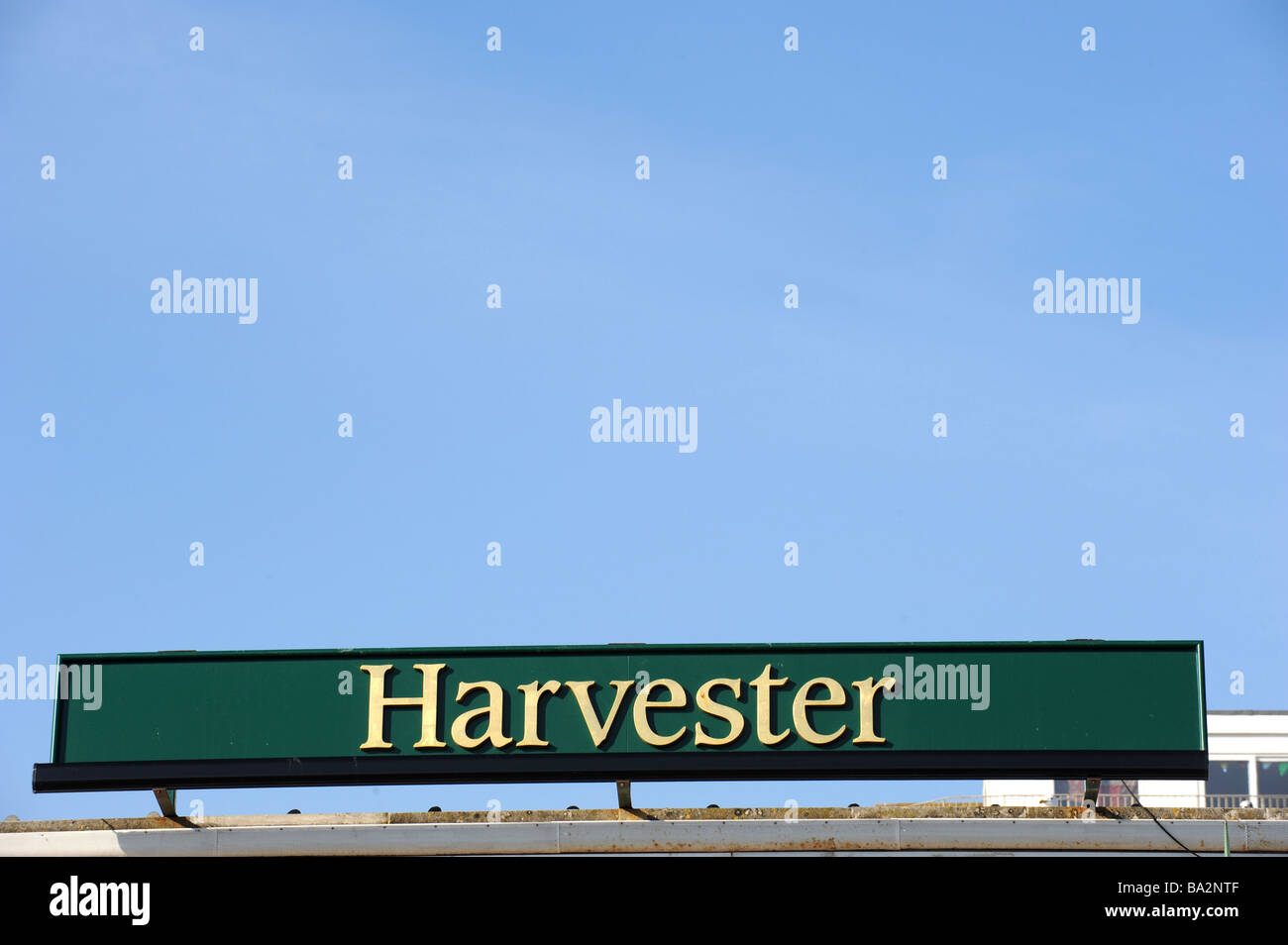 Harvester pub sign against a blue sky Stock Photo