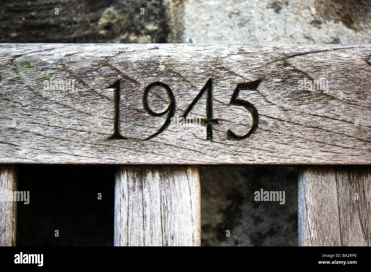 Year 1945 chiselled into grainy wood Stock Photo