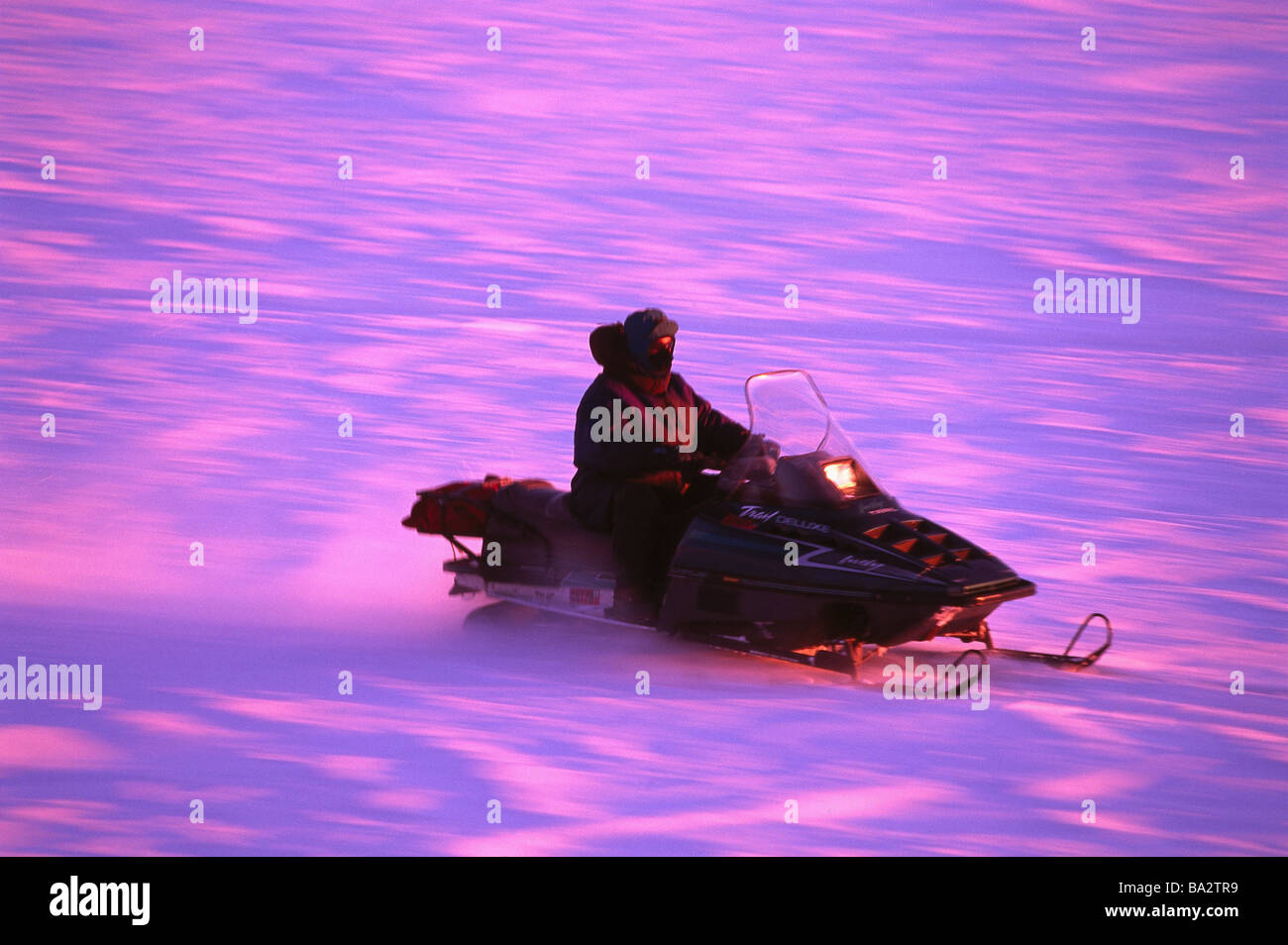 Man motor-sleighs snow winters sunset people Ski-doo leisure time vehicle means of transport transportations concept mobility Stock Photo