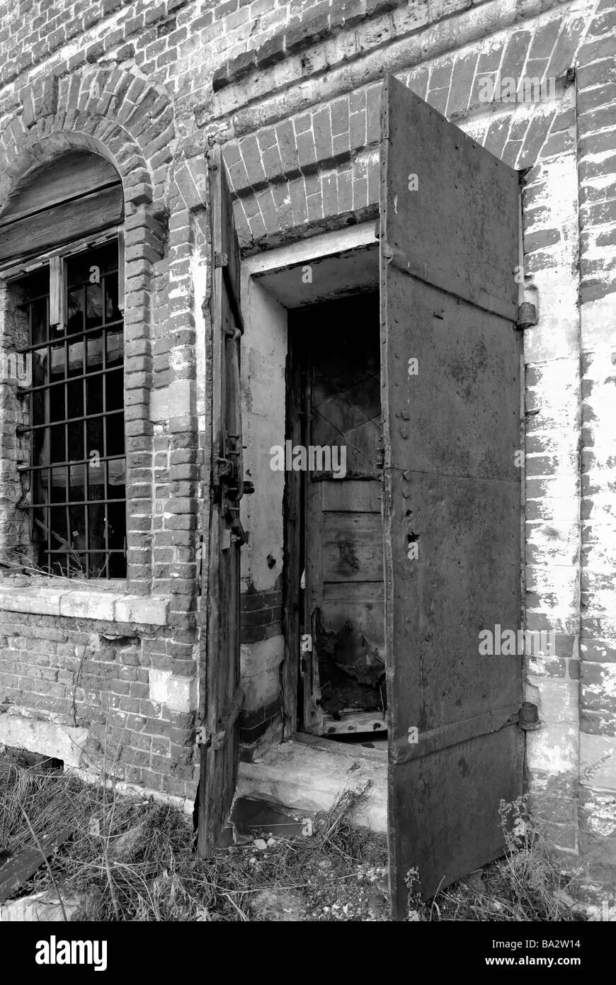 Open door into destroyed during Soviet period Russian country church Vladimir region Russia Black and White Stock Photo
