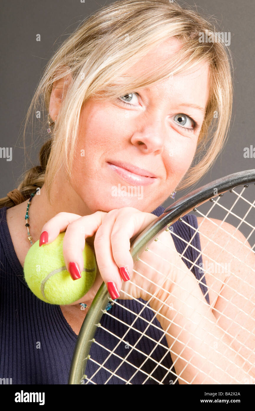 happy smiling female tennis player with racquet and ball healthy lifestyle concept Stock Photo