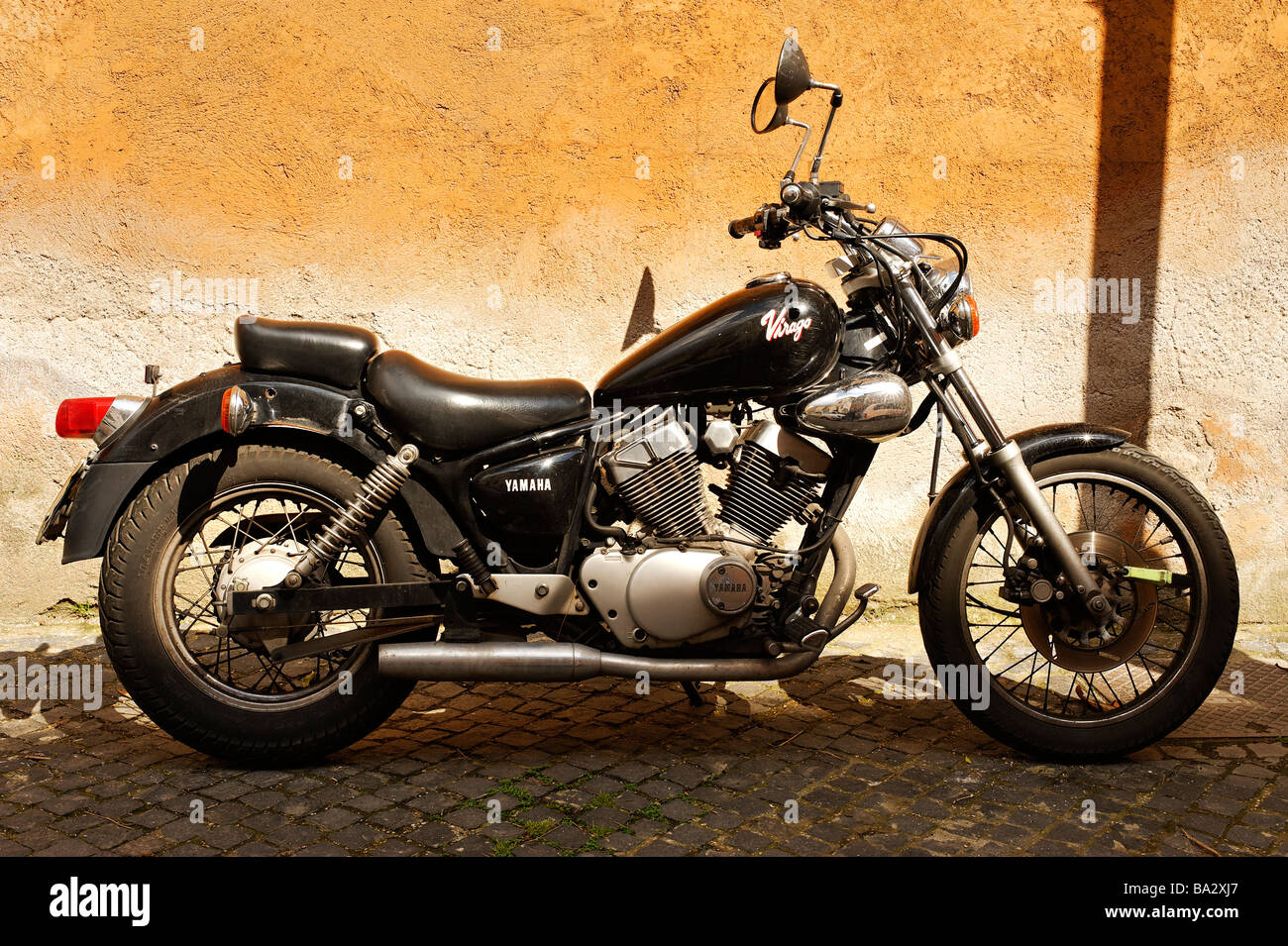 Motor bike parked in back street in Rome, Italy Stock Photo