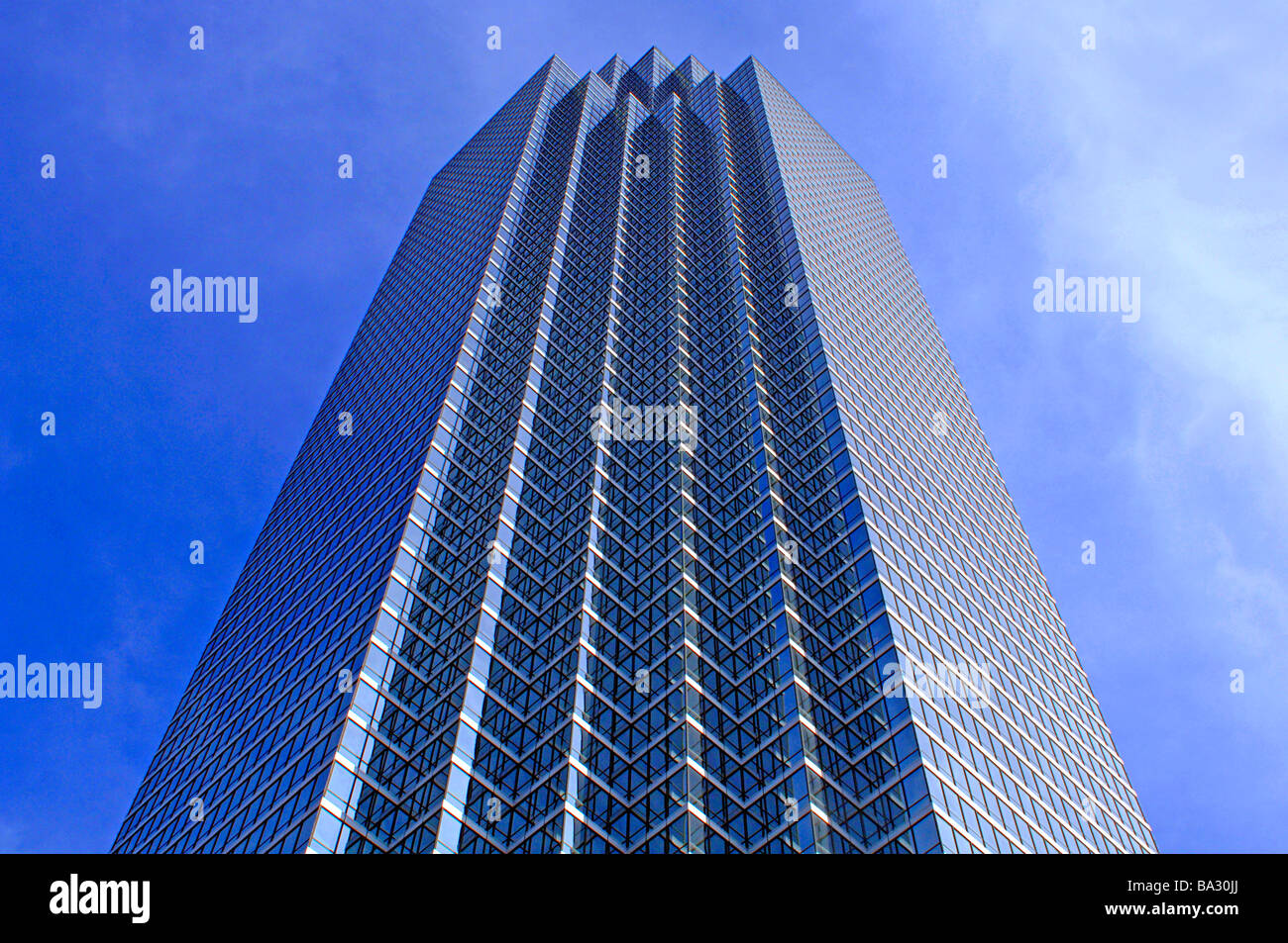 Towering modern glass skyscraper in an urban city Stock Photo