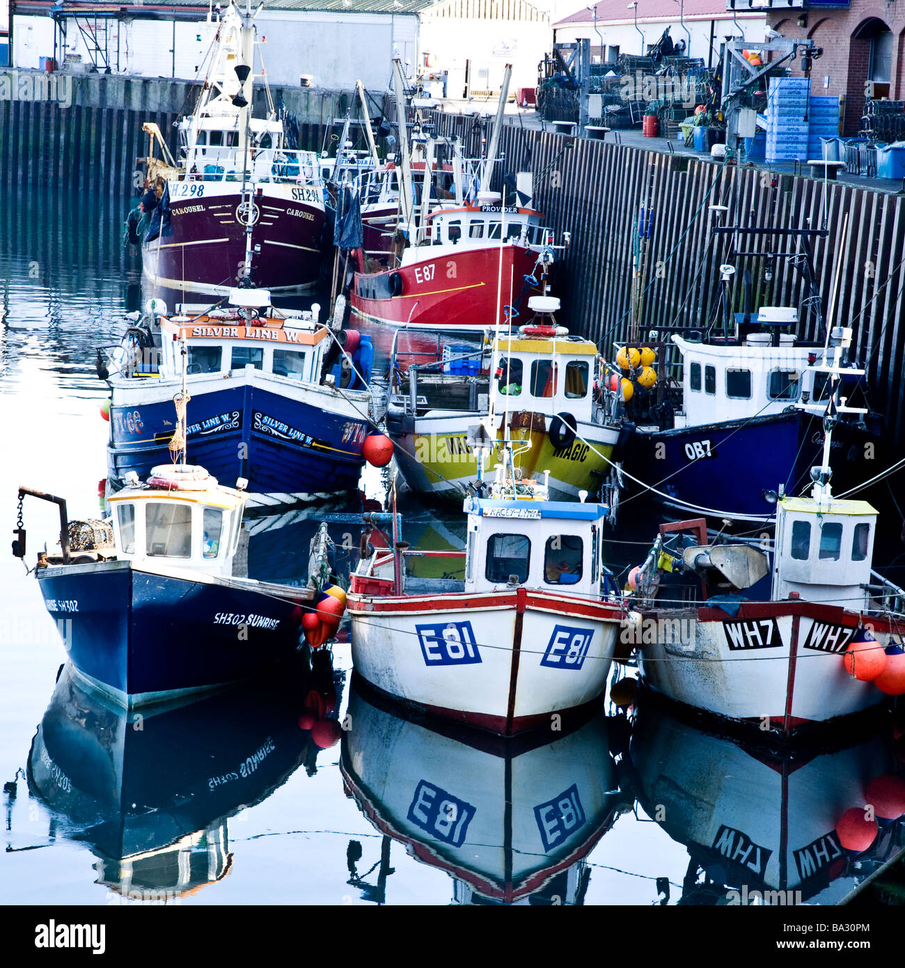 Fishing boats unloading at Scarborough Docks, North Yorkshire Stock Photo
